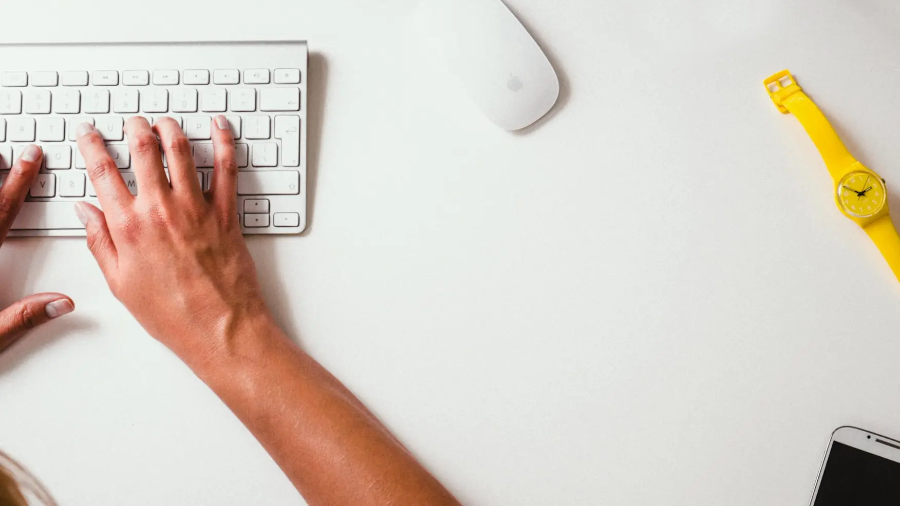 person typing on Apple Cordless Keyboard